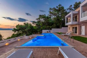 a swimming pool in the backyard of a house at Orizontas by Vintage Travel in Agia Pelagia Chlomou
