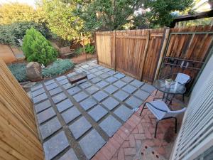 a patio with a fence and a table and a chair at Finch & Fern Guesthouse in Bloemfontein