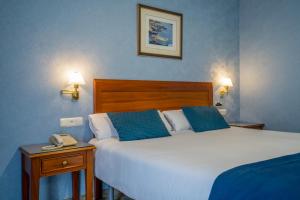 Postel nebo postele na pokoji v ubytování Hotel Bartos