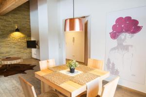 a dining room with a wooden table and a pendant light at Kuckucksnest Schwärzenbach in Titisee-Neustadt