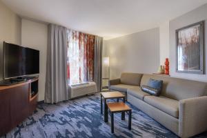 a living room with a couch and a tv at Fairfield Inn & Suites by Marriott Texarkana in Texarkana