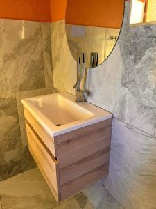 y baño con lavabo y espejo. en BKT Boutique Lodge en Ga-Matsi