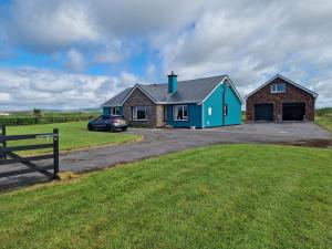 a house with a car parked in front of it at Shanadune in Tralee