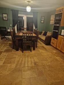 a living room with a table and chairs and a couch at Shanadune in Tralee