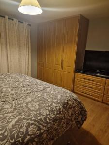 a bedroom with a bed and a flat screen tv at Shanadune in Tralee