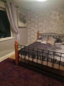 a bedroom with a bed with a wrought iron frame at Shanadune in Tralee