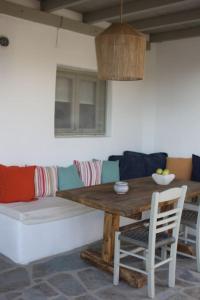 a living room with a couch and a wooden table at A casa d’ Irene in Kampos Paros