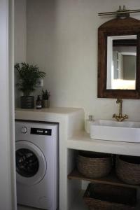 a bathroom with a washing machine and a sink at A casa d’ Irene in Kampos Paros