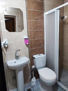 a bathroom with a toilet and a sink at Fatih Hotel Erciyes in Istanbul