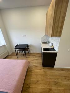 a kitchen with a sink and a table in it at Airport Apartment 22 Self Check-In in Vilnius