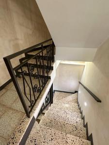 a staircase with a wrought iron railing in a building at ARA Home in Marcellinara