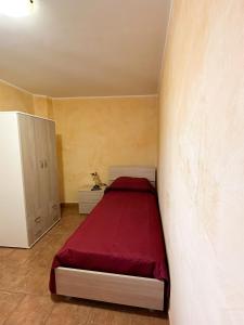 a small bedroom with a red bed in a room at ARA Home in Marcellinara