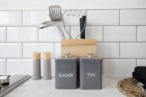 two trash cans sitting on a kitchen counter at Beautifully presented newly renovated city-centre apartment in Cheltenham in Cheltenham