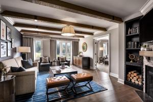a living room filled with furniture and a fireplace at Fairmont Chateau Whistler in Whistler