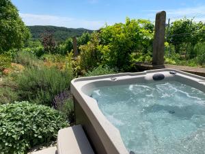 a jacuzzi tub in a garden with a view at Káli Panorama Resort in Mindszentkálla