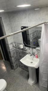 a bathroom with a white sink and a toilet at Apart-Hotel Vasilisa EVN Airport in Pʼarakʼar
