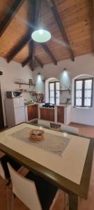 a kitchen with a large table with chairs at Holiday Villa Old Qeparo in Qeparo