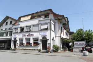 a white building on the corner of a street at Hotel da Luca in Herzogenbuchsee