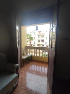 Habitación con balcón y vistas a un edificio. en Maison en lieu calme en El Jadida