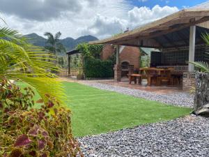 a patio with a table and green grass at Driftwood and Jolie cottages in Sam Roi Yot