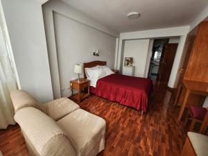 sala de estar con cama y sofá en Hotel Oceano Mit, en Tacna