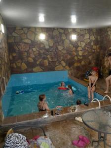 a group of people in a swimming pool at Zau Vila in Grigoleti