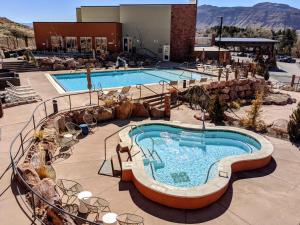 a large swimming pool in a resort at Hyatt Place Moab in Moab