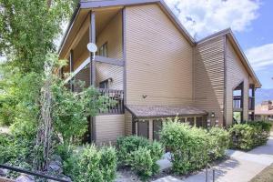 une maison avec un balcon et des buissons en face de celle-ci dans l'établissement Wolf Creek Lodge Condo in Eden, UT - Relaxing Mountain Retreat, à Eden