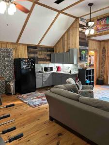 a living room with a couch and a kitchen at The Barn Loft 