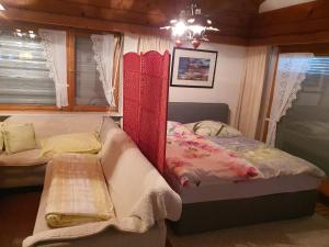 a bedroom with a bed and a bench in it at DreamlandRanch Vorarlberg in Schlins