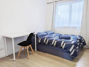 1 dormitorio con cama, escritorio y silla en *Promo* 2-Bedroom Villa Next to Train Station!, en Melbourne