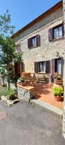 a stone building with a picnic table in front of it at Casa Badia in Radda in Chianti