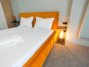 a bedroom with a large bed with a wooden headboard at The Palm Studio in Mamaia