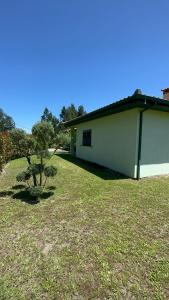 a white building with a small tree in a yard at Casa Cataleia VILLA INN in Ponte de Lima