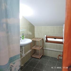a bathroom with a sink and a mirror and a sink at Apartments Dobra Vila in Zlatibor