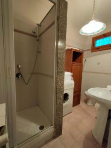 a bathroom with a shower with a toilet and a sink at Casa Anversa in Anversa degli Abruzzi +4 photos