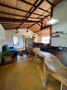 a large room with a large wooden table in a room at Chalés Vista das Montanhas in Lavras Novas