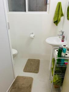 a small bathroom with a sink and a toilet at CasaBlancaGrand Colibrí in Acapulco