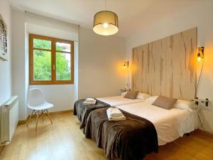 Postel nebo postele na pokoji v ubytování Apartamentos Puente La Reina