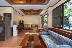 a living room with a couch and a table at Patong Central Hotel & Apartment in Patong Beach