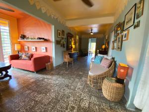 un soggiorno con divano rosso e sedie di Casa de Amistad Guesthouse a Vieques
