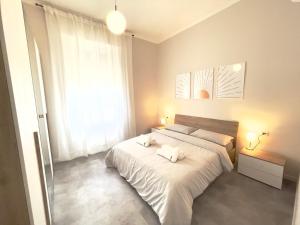 a bedroom with two beds and a large window at KATUA Cozy Apartment - close to the downtown in Pavia