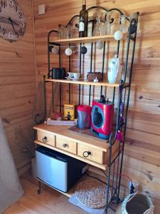 a shelf with pots and pans on it in a room at Roulotte en bois in Fuveau