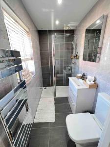 a bathroom with a shower and a toilet and a sink at Stunning Home in Astley in Tyldesley