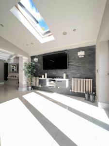 a living room with a flat screen tv on a wall at Stunning Home in Astley in Tyldesley