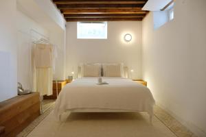 a bedroom with a white bed and a window at Lisbon City Villa in Lisbon