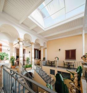 an indoor lobby with a skylight in the ceiling at Le Corti - Dimora storica in Polistena