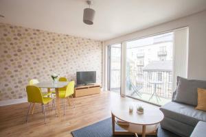 a living room with a couch and a table at 1 Bedroom Flat in the Heart of Merchant City in Glasgow