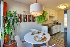 a kitchen and dining room with a white table and chairs at Quiet San Diego Condo with Balcony, Pool, Hot Tub! in San Diego