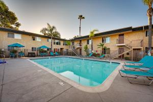 a swimming pool at a hotel with blue lounge chairs at Quiet San Diego Condo with Balcony, Pool, Hot Tub! in San Diego